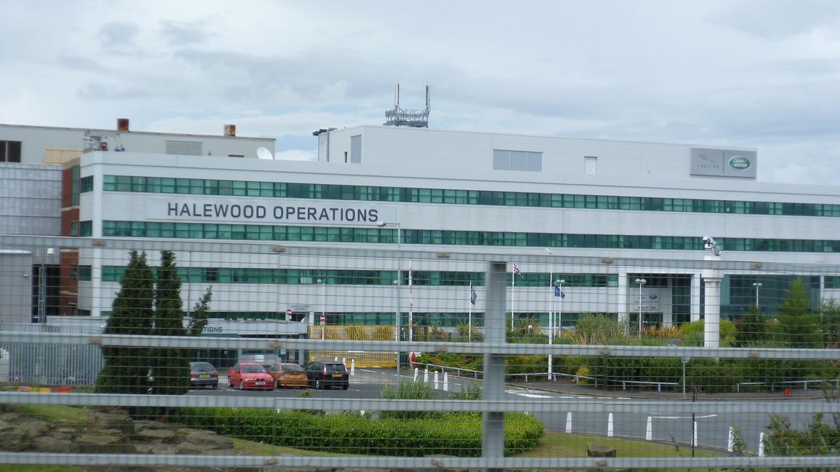 Jaguar Land Rover's Halewood Operations building, seen through a fence.